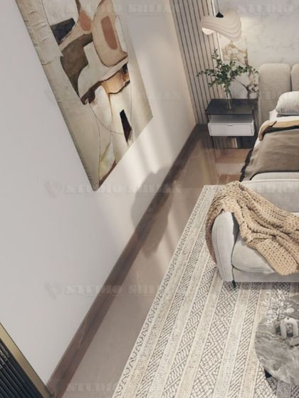 An overhead view showing the layout of the seating area in the bedroom, with a comfortable sofa and marble-topped coffee tables.