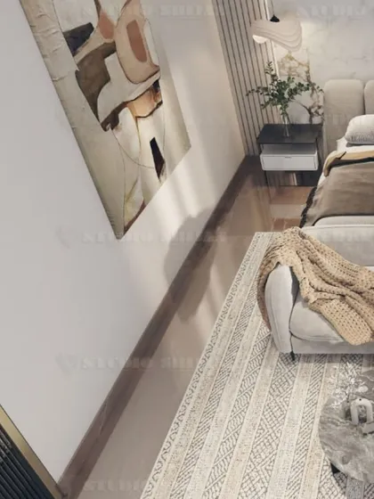 An overhead view showing the layout of the seating area in the bedroom, with a comfortable sofa and marble-topped coffee tables.