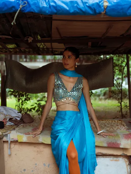 I used to be skeptical of pre-draped saris, but this look changed my mind. This stunning blue draped sari from Goldy's Nestt is paired with orange stockings for a bold, modern twist.