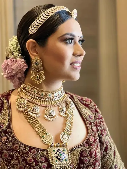 A side profile of a real bride with a classic floral bun. The hairstyle is elegant and timeless, perfect for her wedding day.