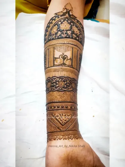 A full-arm bridal design without any human figures. This piece focuses on the beauty of swans and peacocks set within intricate architectural dome patterns.