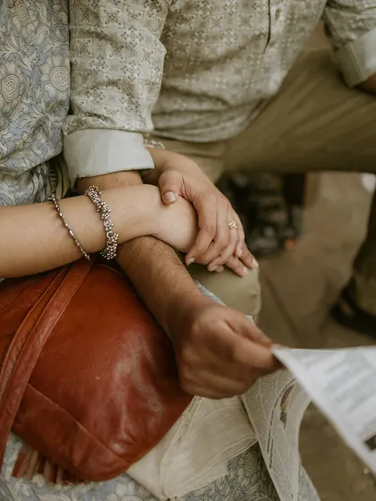 Another beautiful close-up of hands intertwined, focusing on the texture of the bride's saree and the groom's kurta. It’s these small details that enrich the story.