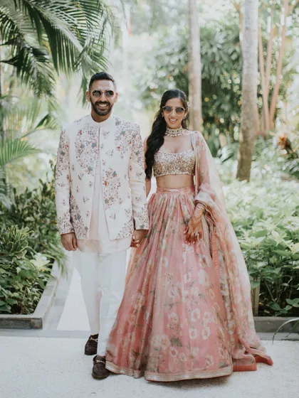 This couple's sangeet style is all about relaxed elegance. Her printed Sabyasachi lehenga and his coordinated Jatin Malik outfit were perfect for walking through the lush gardens of their Bali venue.