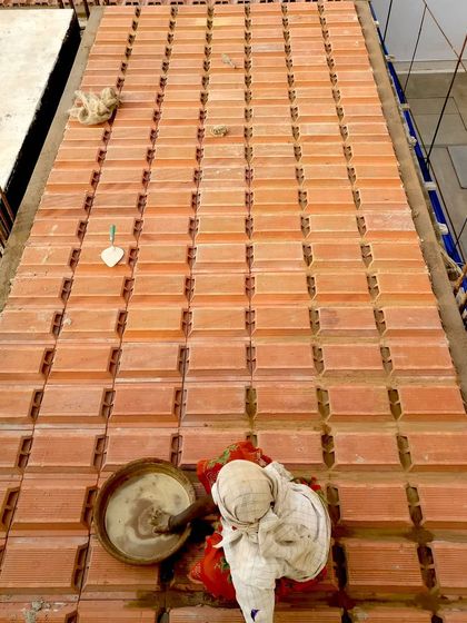 This image shows a filler slab with hollow clay blocks being constructed. This method is central to our sustainable design, as it significantly reduces the amount of concrete needed and enhances the building's natural insulation.