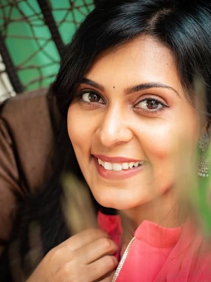 A bright and engaging close-up, with the peacock feather adding a pop of color and texture.