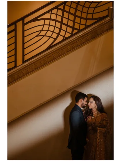 A dramatic portrait using architectural lines and shadows to create a powerful and intimate composition. We love finding unique angles to tell your story.