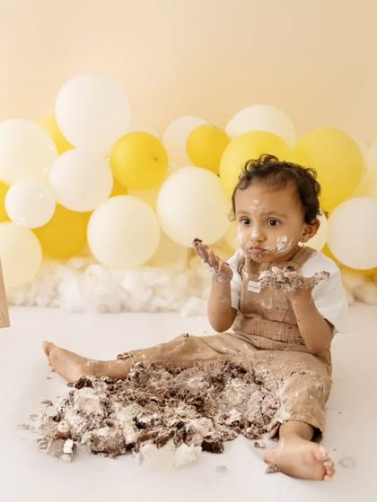 This little one is going all in. A hilarious and adorable shot of a baby fully smashing his cake during a teddy bear themed session.