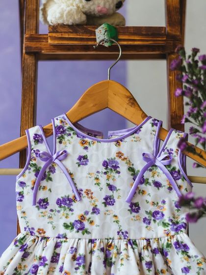 This white dress with a purple floral print is accented with sweet lavender bows on the shoulders. It’s a perfect example of my love for delicate, thoughtful details.