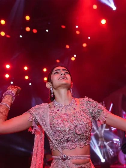 The bride, lost in the music under the vibrant red stage lights. These are the candid moments of pure bliss that I love to see, a sign of a truly successful celebration.