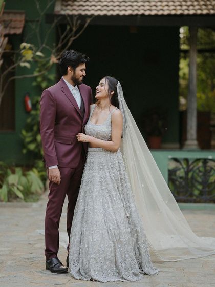 A couple in modern reception attire stands in one of our courtyards, showcasing the venue's suitability for contemporary celebrations.