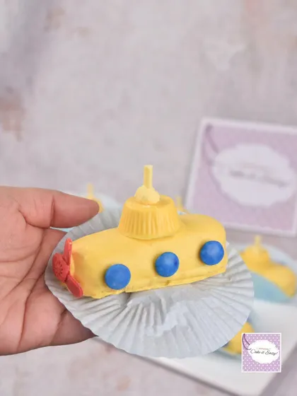 A mini "Yellow Submarine" cake, part of a Beatles-themed dessert set for an 8-year-old fan.