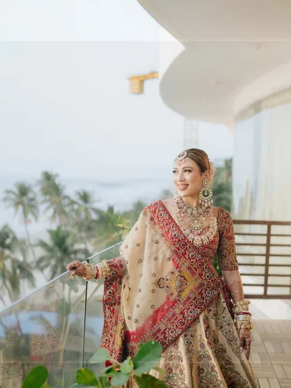 Celebrating our elegant and charming brides every day. This bride enjoys a moment on the balcony overlooking the sea before her beach wedding.