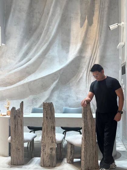 Here I am, standing beside one of the custom-designed chairs made from reclaimed wood. Every piece in La Solitaire was envisioned and crafted as a sculpture, reflecting my belief that furniture should be an integral part of the architectural narrative.