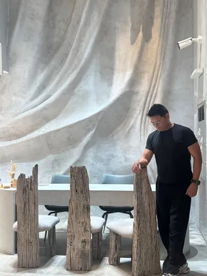 Here I am, standing beside one of the custom-designed chairs made from reclaimed wood. Every piece in La Solitaire was envisioned and crafted as a sculpture, reflecting my belief that furniture should be an integral part of the architectural narrative.