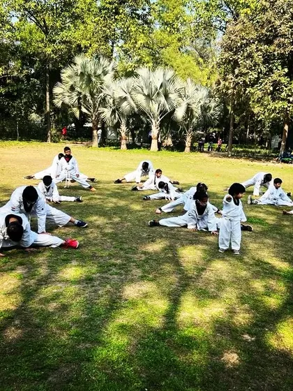 Training isn't confined to the dojo. Here, our students are doing their flexibility and conditioning drills outdoors during a belt test event at Nehru Park.
