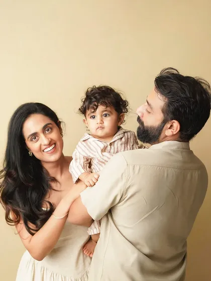 A candid family moment, with the parents looking at their son. The natural interaction makes this portrait feel authentic and full of love.