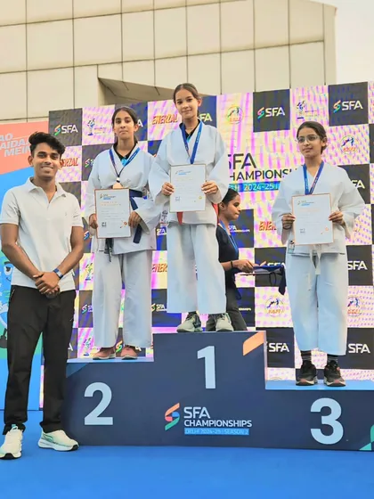 Standing with my students on the podium. Their success is a reflection of the high standards we maintain.