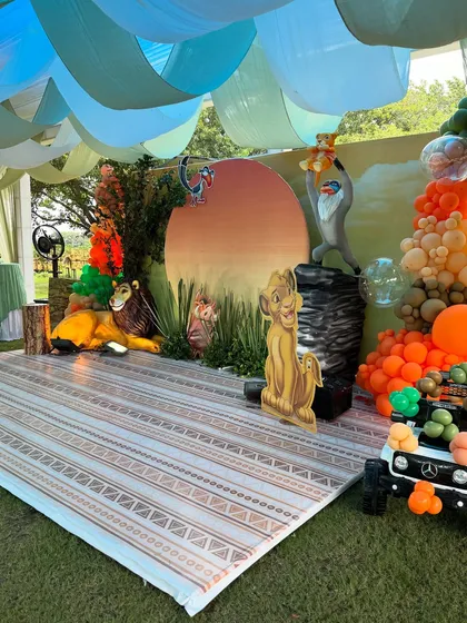 Another angle of the Lion King outdoor stage, showing how the elements come together, including a mini jeep filled with balloons for a fun photo prop.