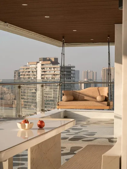 For this sea-facing Mumbai terrace, we designed a serene escape with a custom daybed and a sleek, reversible swing. The furniture is designed to be both durable for the outdoors and elegant enough to complement the stunning city views, creating a perfect spot for lazy afternoons or lively evenings.