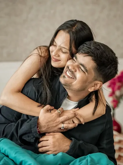 A cozy and candid moment from an at-home pre-wedding shoot, showing a different, more personal side of the couple's story.