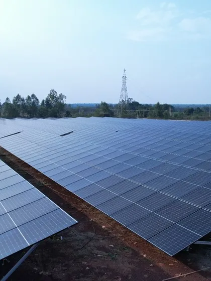 A wide-angle shot of the 1.3 MW solar installation at sunrise, capturing the vast expanse of clean energy generation. This plant is a significant step towards a sustainable energy future.