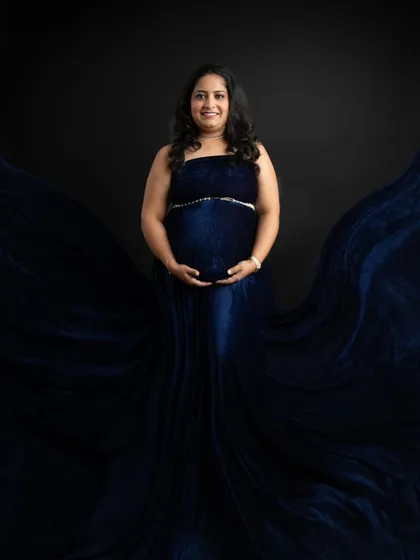 A powerful and symmetrical pose with the flowing blue gown creating a wing-like effect. This shot feels so strong and beautiful, celebrating the creative power of motherhood.