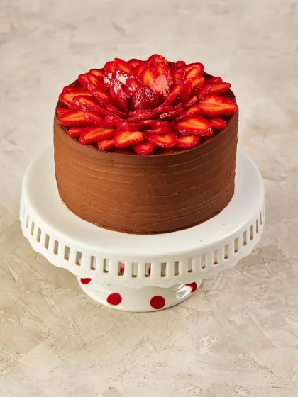 Our Chocolate & Strawberry Cake is a classic combination. The rich chocolate cake is the perfect base for the fresh, sweet strawberries on top.