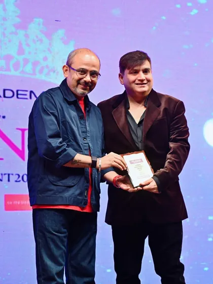 Sharing a smile while receiving the Global Achievers Award. These moments are a testament to the hard work and passion that goes into every project.
