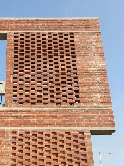 Materials tell a story. This intricate brick screen, or 'jali', is crafted from locally sourced brick, showcasing our commitment to contextual design. It filters light beautifully and provides passive cooling, blending heritage with performance.
