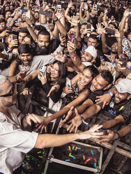 The view from the barricade. DJ Snake reaches out to touch hands with his most dedicated fans in the front row.