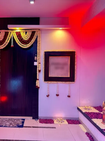 The festive feeling starts at the door. For this home celebration, we decorated the entrance with traditional flower garlands and a path of scattered rose petals and candles.
