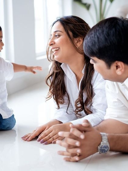 A family playing together on the floor.
