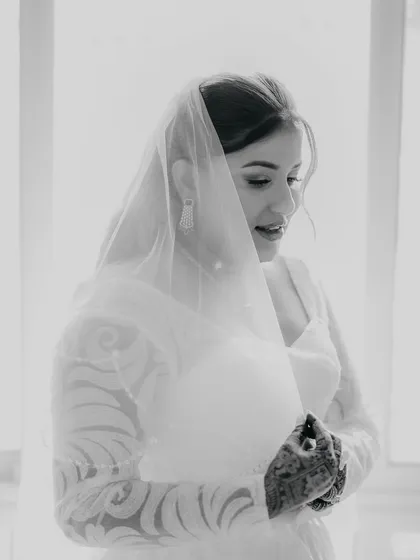 An elegant, soft-lit portrait of a Christian bride before her ceremony. I use creative lighting techniques to capture the serene and beautiful moments of getting ready.