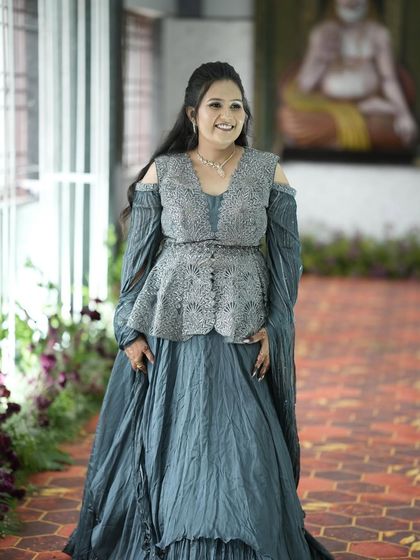 Sahana looking elegant in her grey gown. The half-up, half-down hairstyle is soft and romantic.