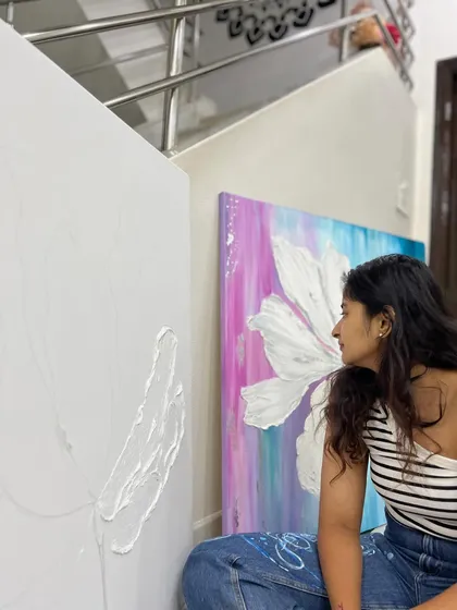 Looking at a blank canvas with the first strokes of texture applied. It's a moment of pure potential, with a finished piece from the same series nearby to guide my vision.