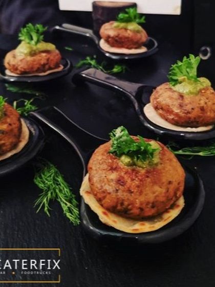 These are my Galouti kebabs served on a mini paratha with a dollop of mint chutney. They are incredibly soft and flavourful, a classic choice for events featuring rich North Indian cuisine.