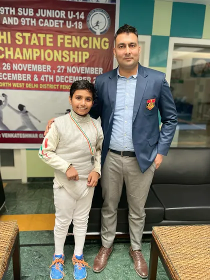 A young medalist from the U-14 category with his coach. We focus on nurturing talent from a very young age.