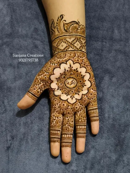 A gorgeous, intricate mandala design with the client's name 'Zakia' written in Arabic in the center.