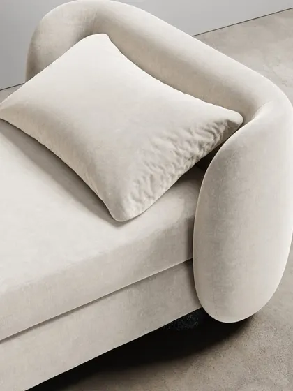 A close-up of the Divan's curvaceous form and its easeful bouclé fabric. The modern union of comfort and elegance makes you feel drawn into its motherly embrace.