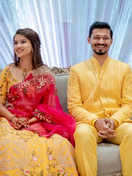 A happy couple in coordinated yellow outfits. Her fresh and radiant makeup is perfect for a Haldi or Mehendi ceremony.