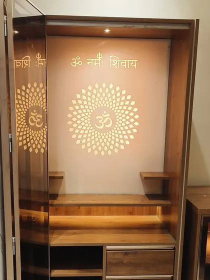 I design and craft beautiful pooja units that become the spiritual heart of a home. This mandir features intricate backlit jali work with the 'Om' symbol and 'Om Namah Shivay' mantra, built with premium wood and integrated storage.