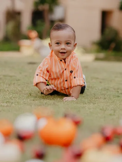 A happy baby crawling on the grass during his pre-birthday shoot. I focus on capturing their natural movements and joyful expressions.