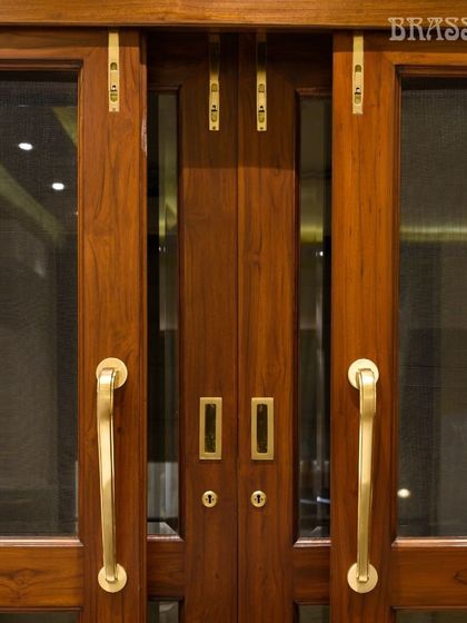A straight-on view of the Talisha door pulls, emphasizing their balanced design and the flawless integration of multiple hardware pieces for a complete door solution.
