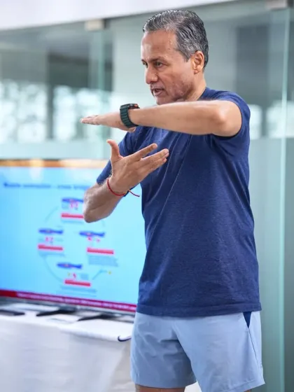 A key part of the course involves understanding muscle contraction cycles. Here, I am demonstrating the physical cues associated with different phases of an EMS pulse, ensuring trainers can guide clients effectively.