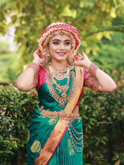 A series of images capturing the joy and beauty of a model in a traditional South Indian bridal look, complete with an elaborate floral headpiece. The focus is on her expressive smile and the rich textures of her attire.