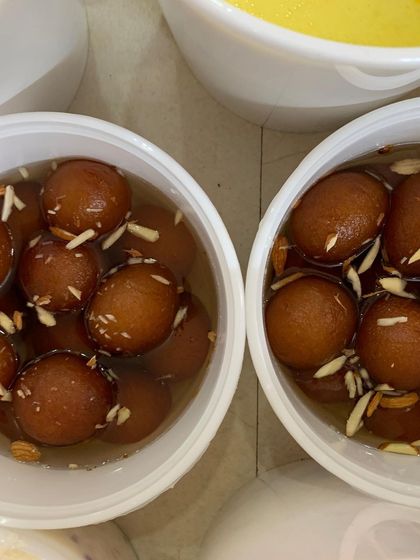Bowls of sweet Gulab Jamuns, a perfect dessert to complete a catered lunch for a large workshop.