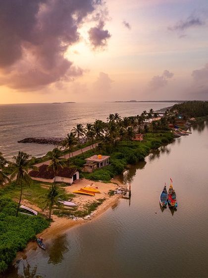 A duplicate of image 19, an aerial shot of a spit of land with kayaks on the shore, under a dramatic sunset sky.
