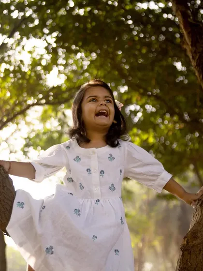 Life is an endless playground with little ones around. Climbing a tree with a look of pure delight, this photo captures the adventurous spirit of a child celebrating her birthday.