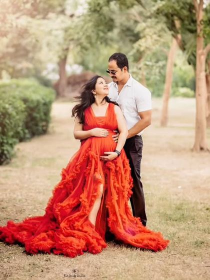 A romantic portrait of an expecting couple in a beautiful park setting. The soft, natural light of our outdoor sessions creates a warm and intimate feel.
