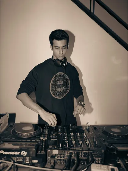 A sepia-toned photo of me at the decks, focused on the controls. It's all about precision and feel.